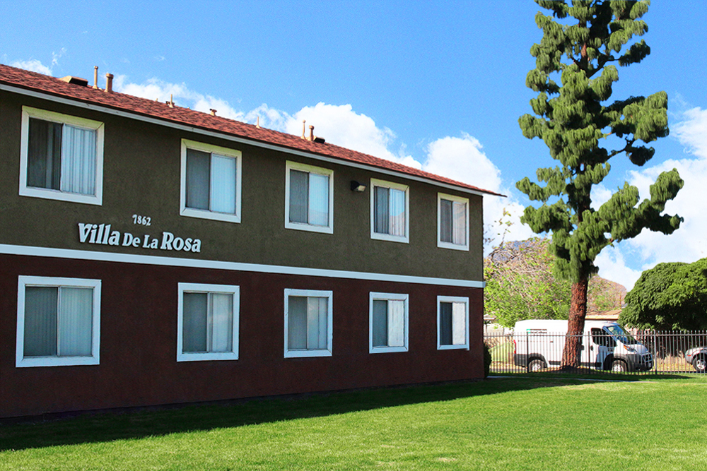 This image displays entrance marker photo of Villa De La Rosa Apartments
